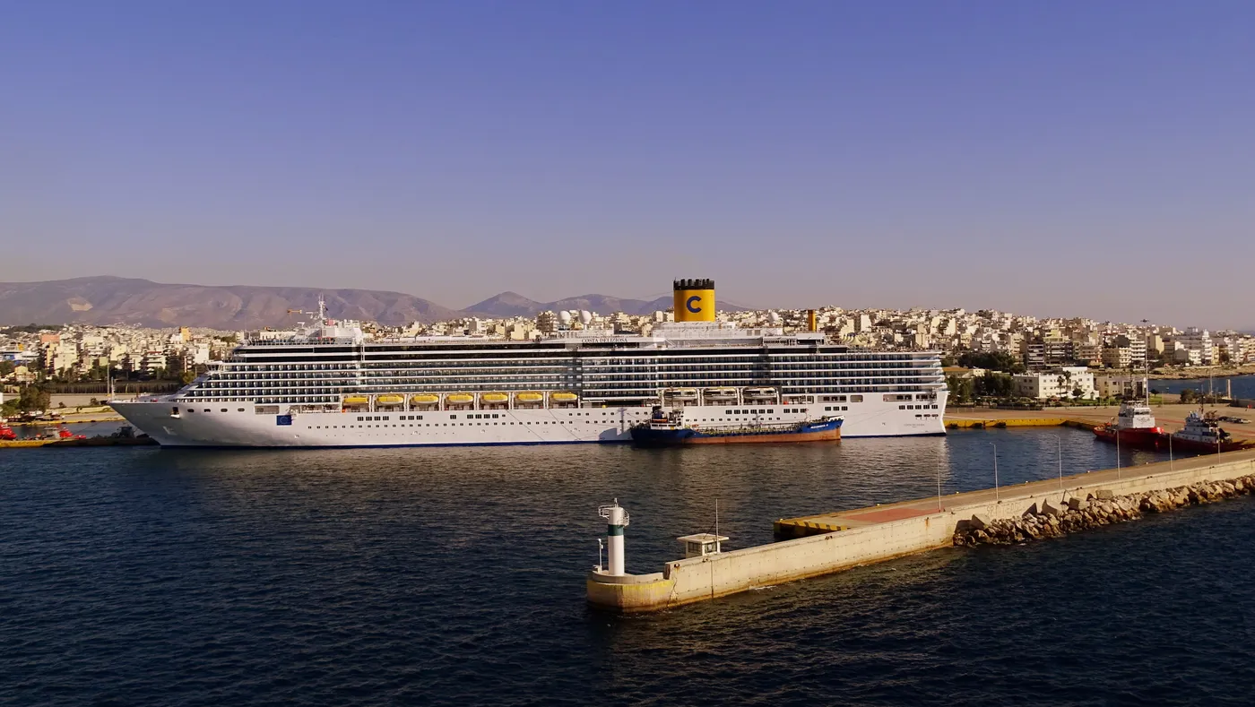 Cruise ship and harbour entrance lighthouse at the port of Piraeus
